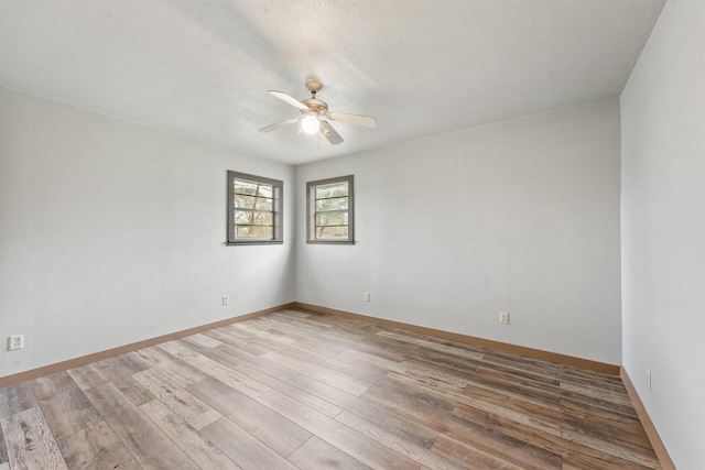 unfurnished room with ceiling fan, hardwood / wood-style floors, and a textured ceiling