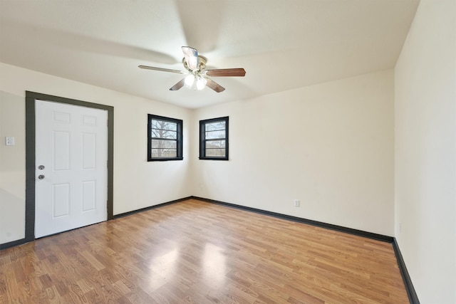 empty room with light hardwood / wood-style flooring and ceiling fan