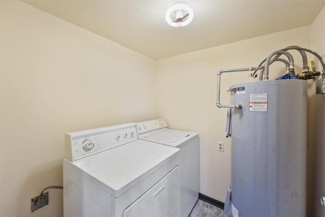 laundry room featuring washing machine and dryer and water heater