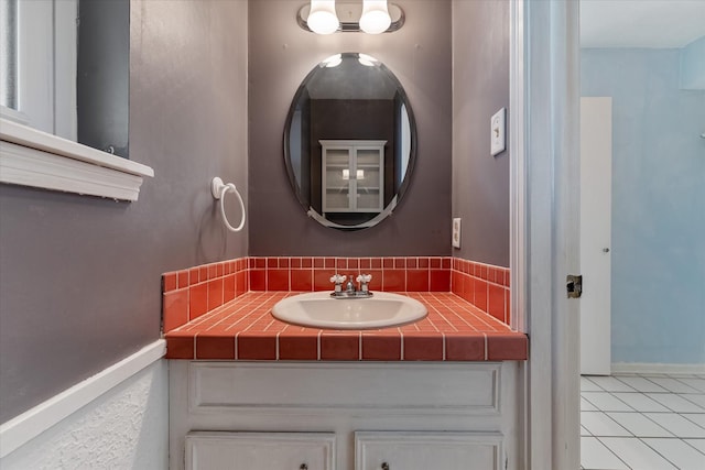 bathroom with tile patterned flooring and vanity