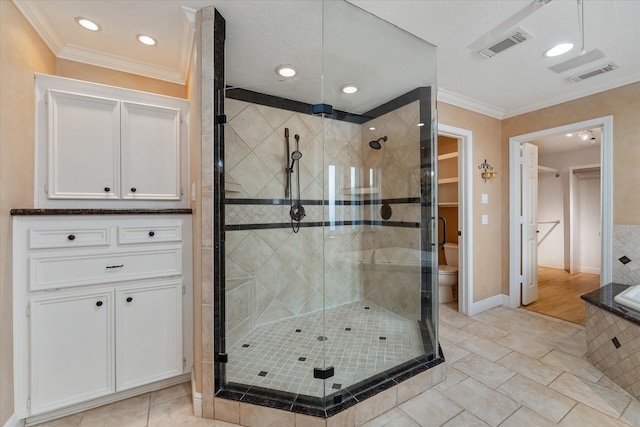 bathroom with ornamental molding, shower with separate bathtub, and toilet