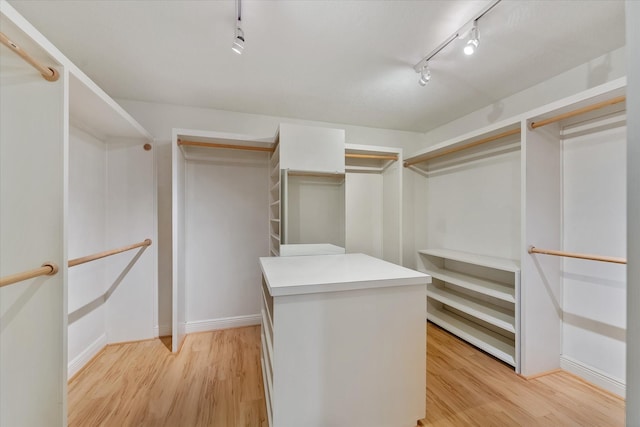 spacious closet featuring light wood-type flooring