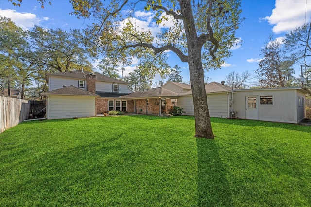 back of property featuring a lawn