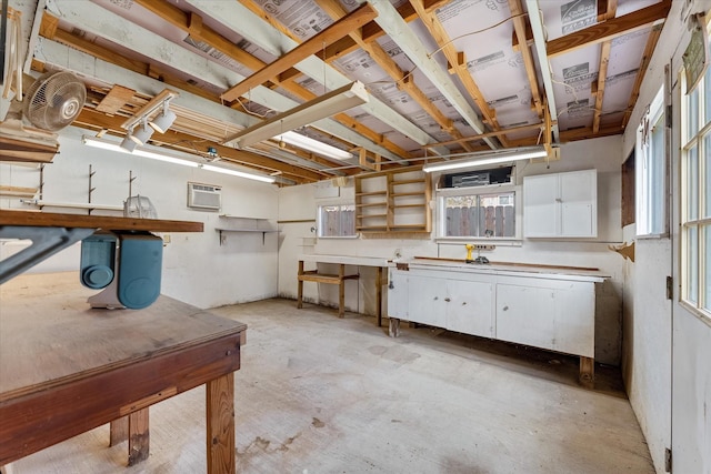 basement featuring a wall mounted AC and a workshop area