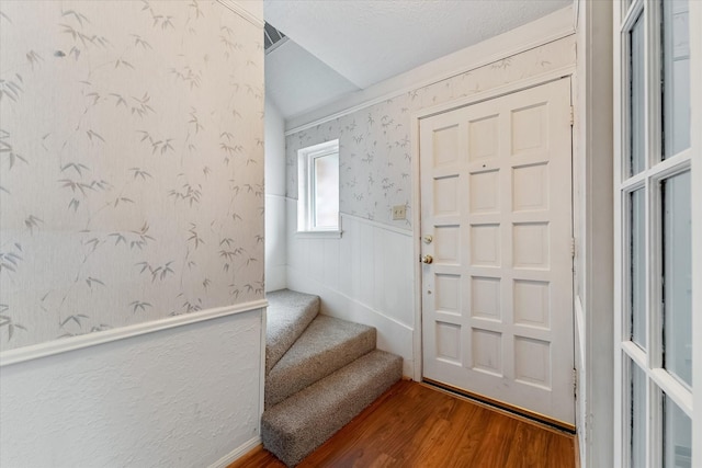 entryway featuring hardwood / wood-style floors and a textured ceiling