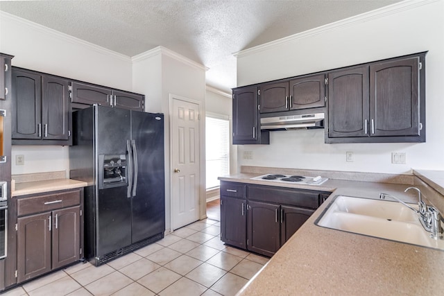 kitchen with black fridge, a textured ceiling, white cooktop, sink, and light tile patterned flooring