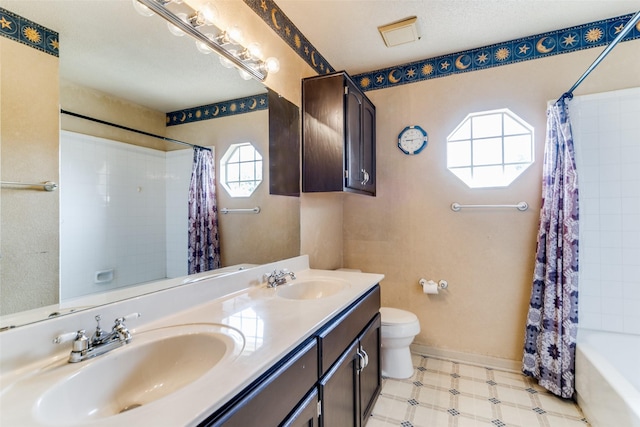 full bathroom with vanity, toilet, and shower / bath combo with shower curtain