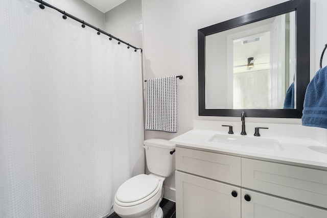 bathroom with vanity, a shower with shower curtain, and toilet