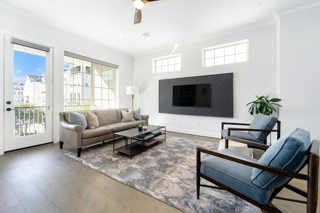 living room featuring ceiling fan, hardwood / wood-style floors, and ornamental molding