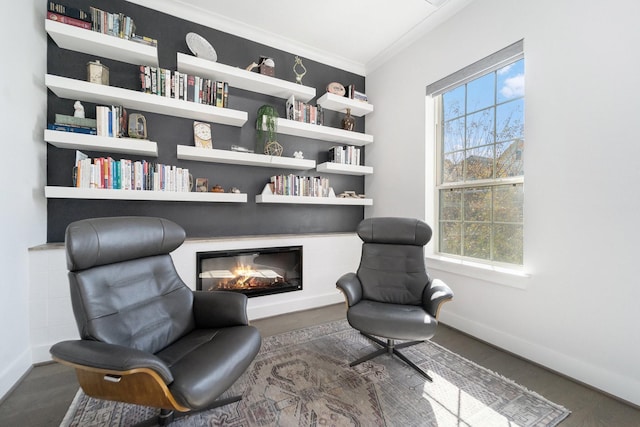 sitting room featuring built in features and ornamental molding