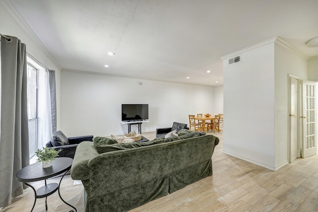 living room featuring ornamental molding and light wood-type flooring