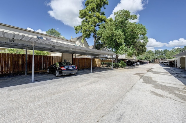 view of parking / parking lot with a carport