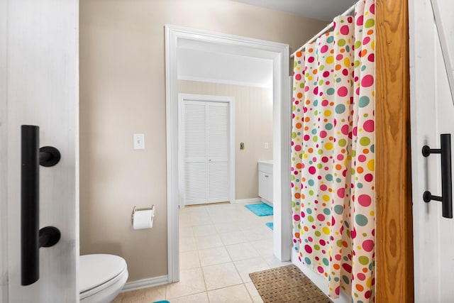 bathroom featuring curtained shower, tile patterned flooring, vanity, and toilet