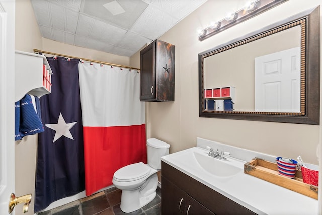 bathroom with vanity, toilet, and curtained shower