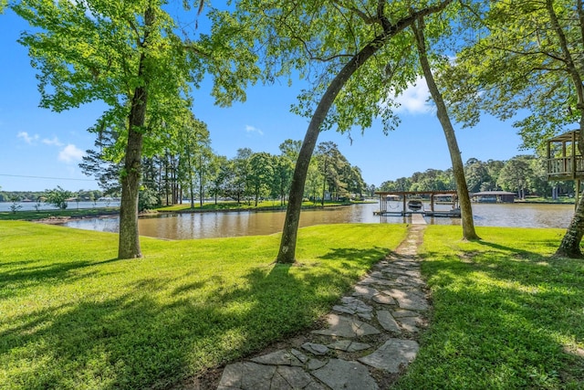 view of yard with a water view and a boat dock