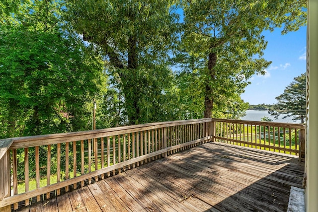 wooden terrace featuring a water view