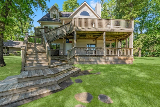 back of house featuring a lawn and a deck