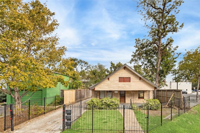 bungalow-style home with a front lawn