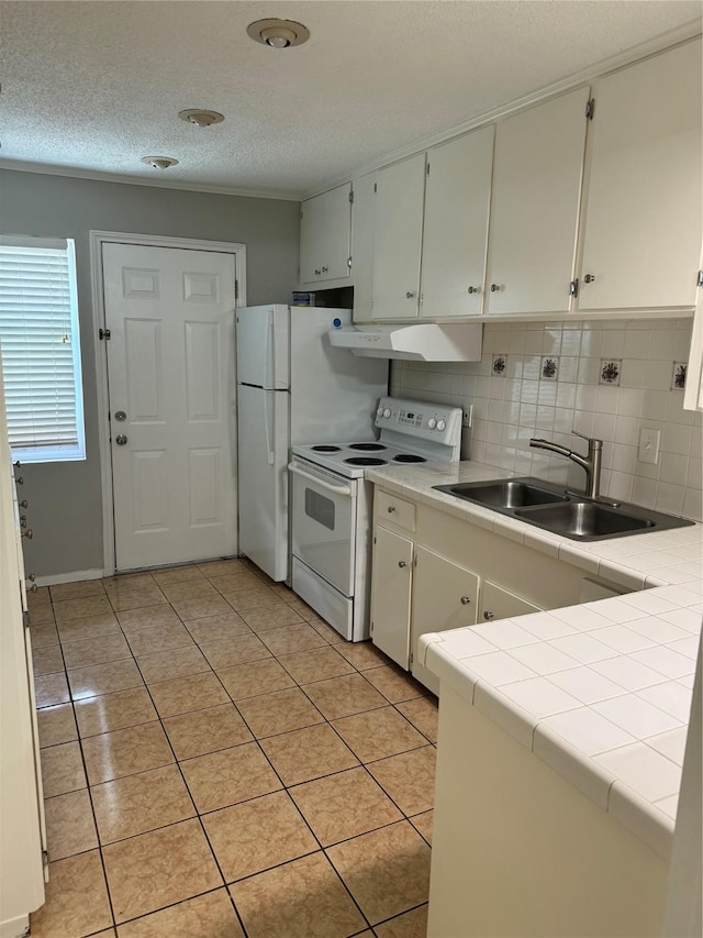 kitchen featuring sink, light tile patterned floors, tile countertops, white electric stove, and white cabinets