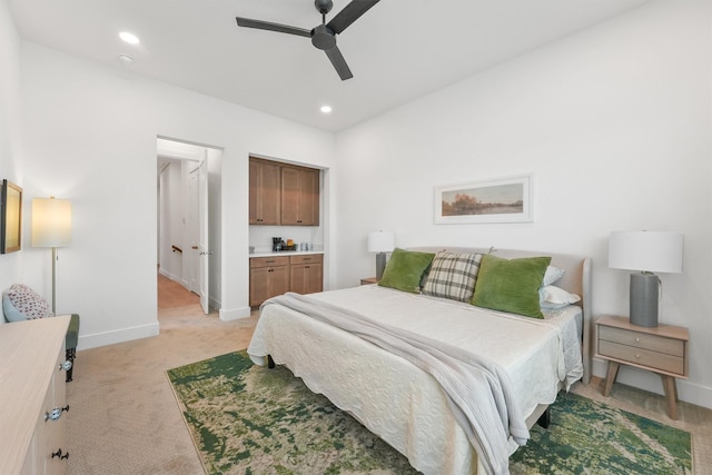 bedroom with ceiling fan and light carpet