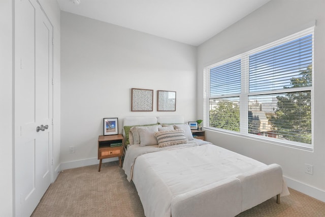 bedroom with light colored carpet