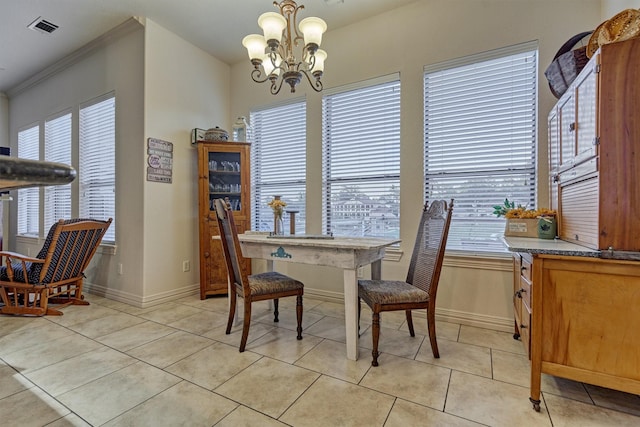 dining area featuring light tile patterned floors, a chandelier, and ornamental molding