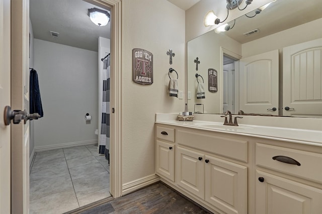 bathroom with vanity and a notable chandelier