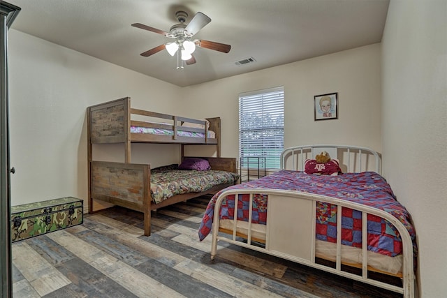 bedroom with ceiling fan and dark wood-type flooring