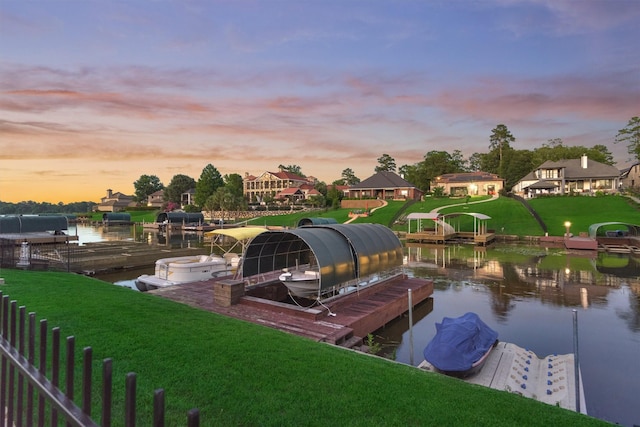 dock area featuring a water view and a lawn