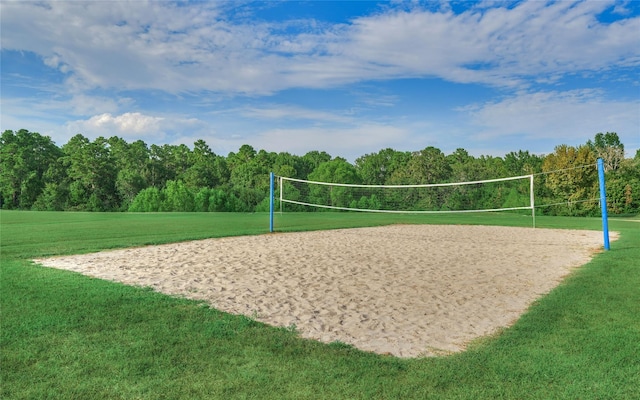 view of community featuring volleyball court and a lawn