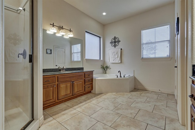 bathroom with tile patterned flooring, shower with separate bathtub, and vanity