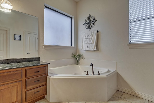 bathroom with tile patterned floors, vanity, and a bathing tub