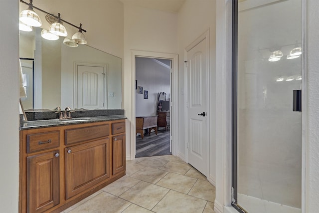 bathroom featuring tile patterned flooring, vanity, and walk in shower