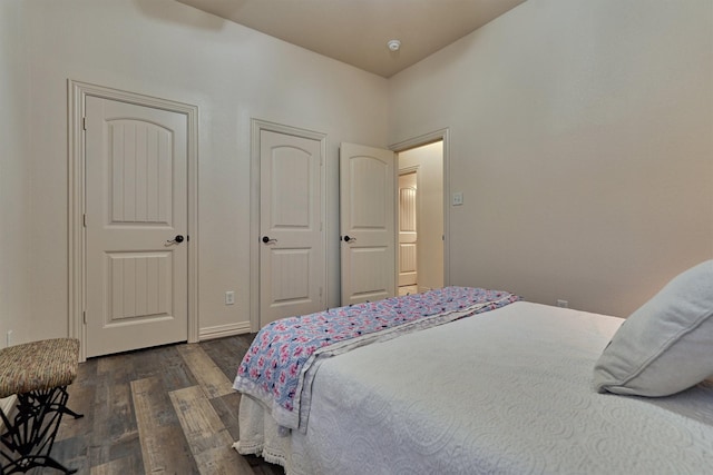 bedroom with dark hardwood / wood-style flooring