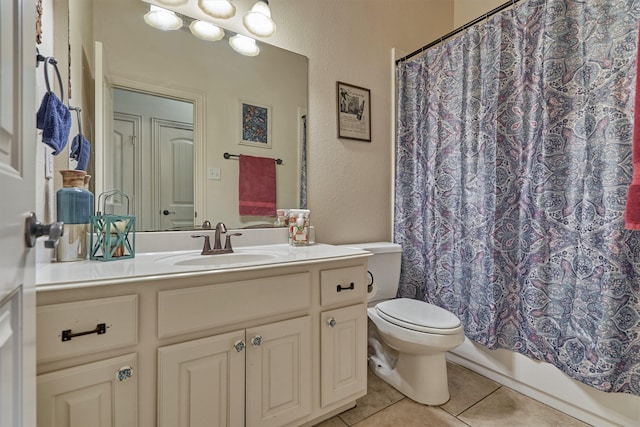 bathroom with tile patterned flooring, vanity, and toilet