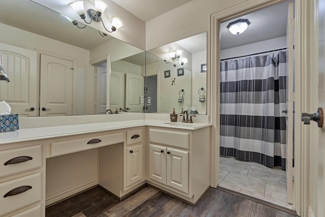 bathroom featuring hardwood / wood-style floors, vanity, and a chandelier