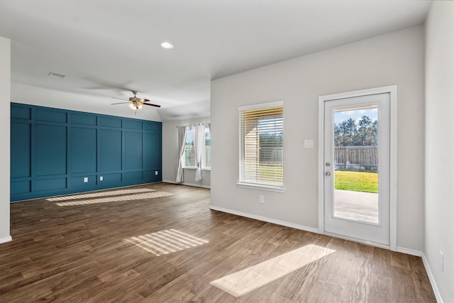 interior space with ceiling fan and dark wood-type flooring