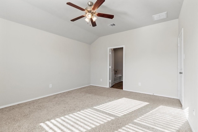 carpeted empty room featuring ceiling fan and lofted ceiling