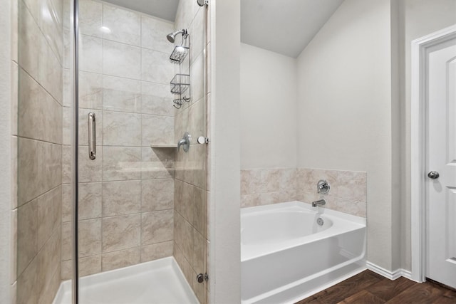 bathroom with wood-type flooring and plus walk in shower