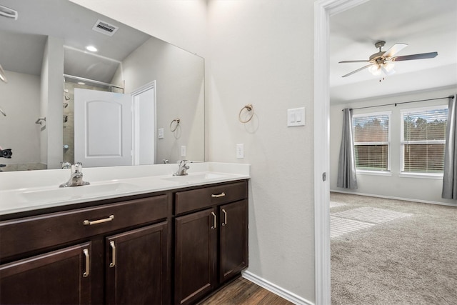 bathroom featuring a shower, vanity, and ceiling fan