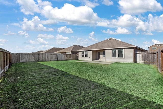 rear view of house featuring a patio and a lawn