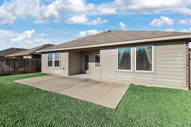 rear view of property with a patio area and a yard