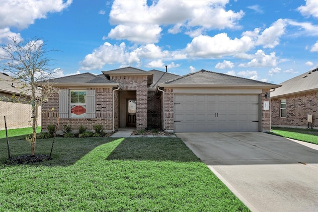 view of front of property featuring a front yard and a garage