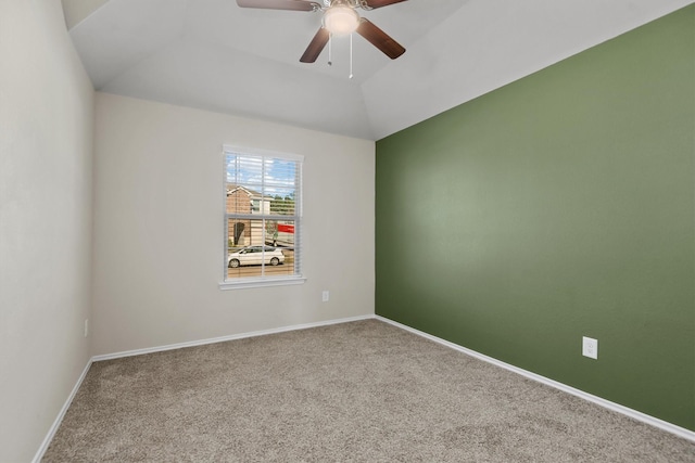 empty room with carpet, ceiling fan, and vaulted ceiling