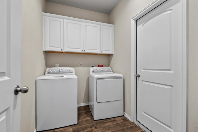 laundry area with separate washer and dryer, dark wood-type flooring, and cabinets