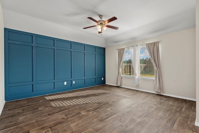 spare room with ceiling fan and dark wood-type flooring