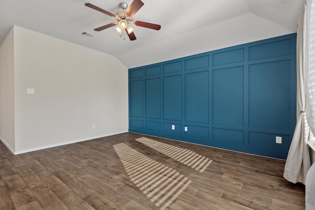 spare room with lofted ceiling, ceiling fan, and dark hardwood / wood-style floors