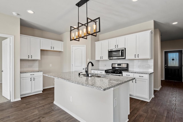 kitchen featuring stainless steel appliances, white cabinetry, and sink