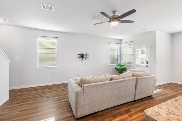 living room with ceiling fan and dark wood-type flooring