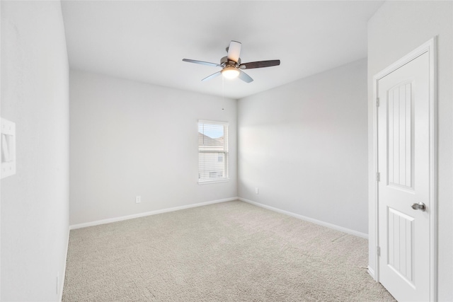 spare room with ceiling fan and light carpet